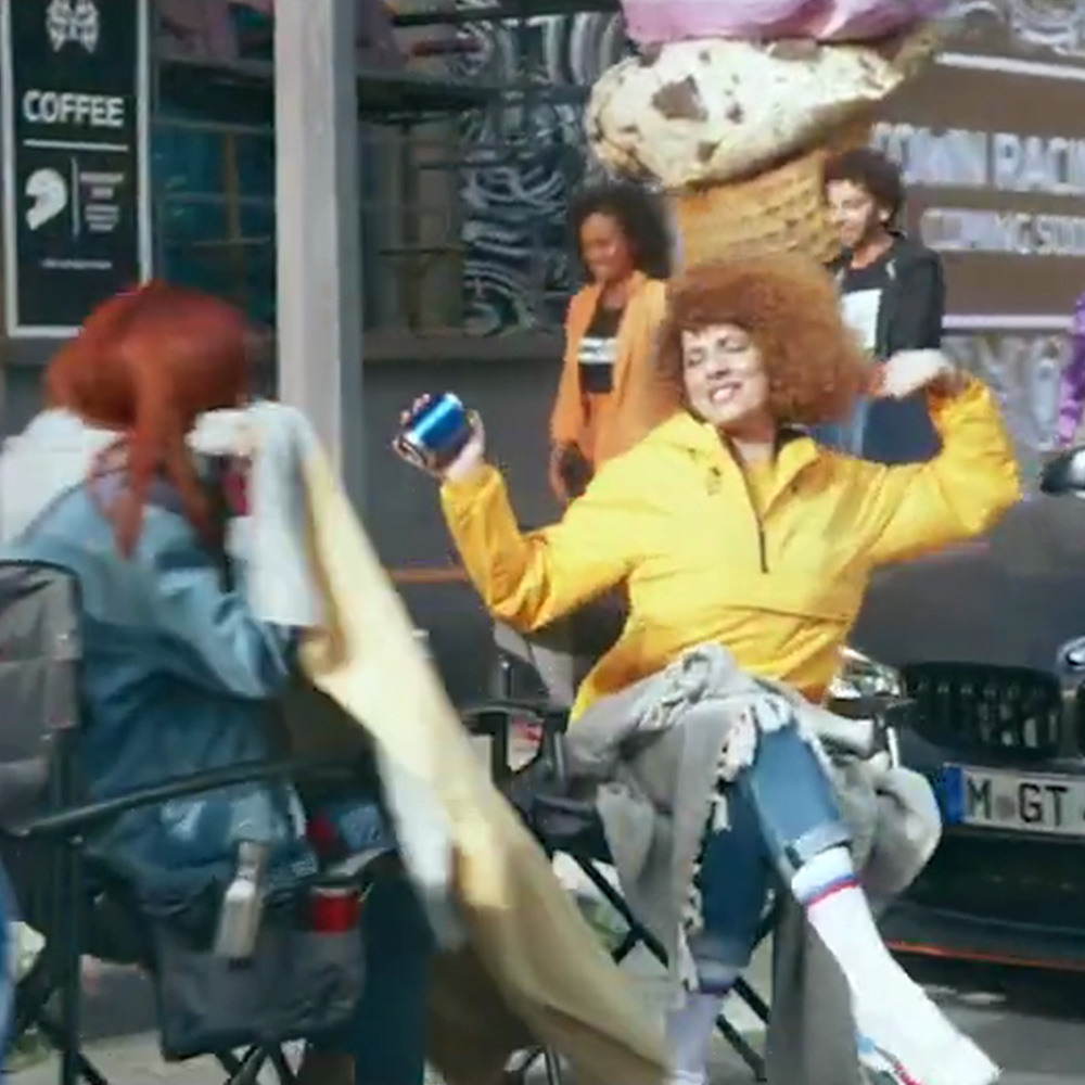Coffee shop scene with woman in yellow jacket and coffee cup