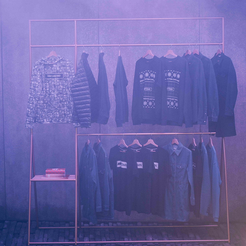 M Town merchandise store interior with clothing racks and neon lighting