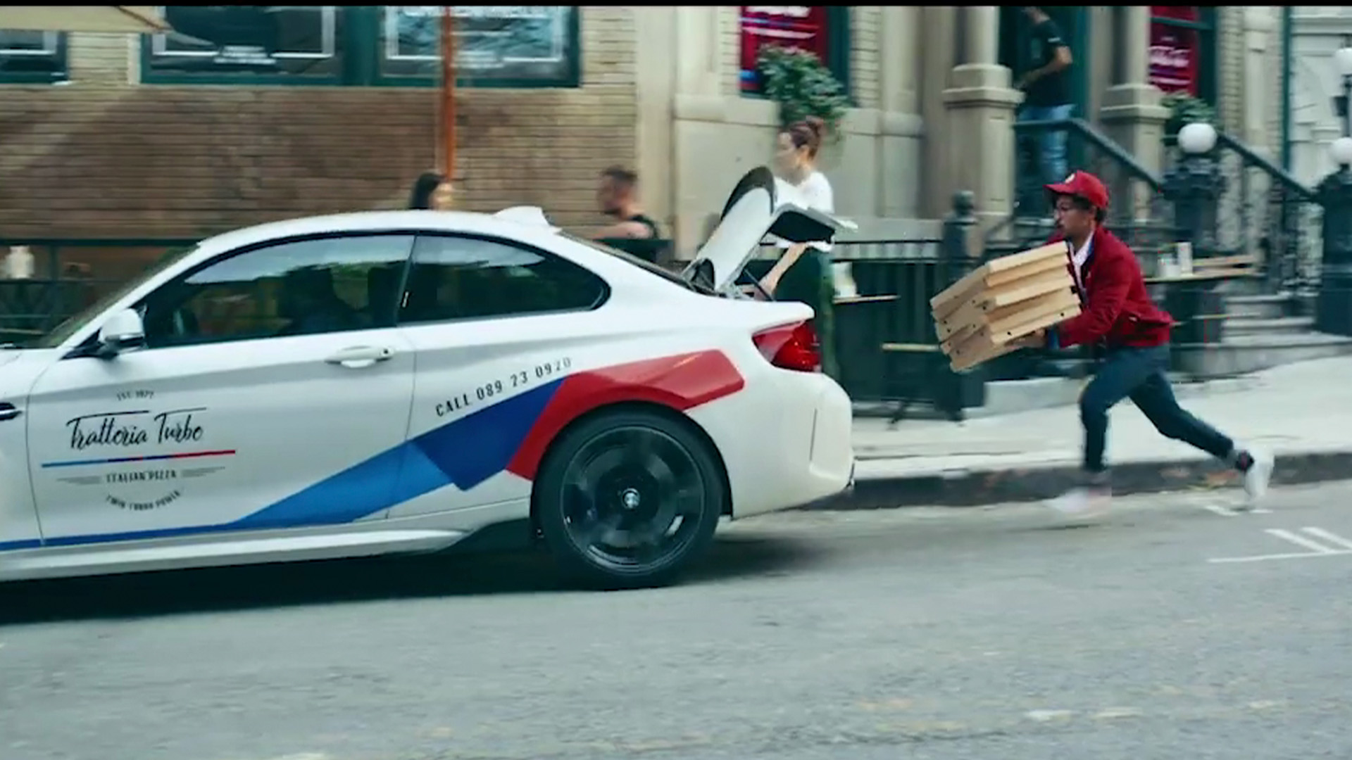 Trattoria Turbo pizza delivery BMW with M colors and delivery boy running
