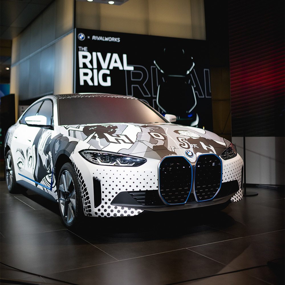 BMW i4 rear view showing manga character wrap on trunk and bumper