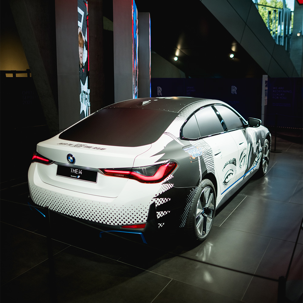 BMW i4 front quarter panel detail with manga speed lines and halftone pattern