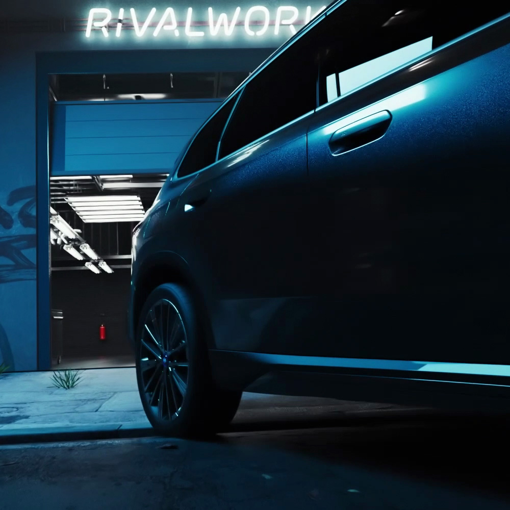 BMW iX3 driving out of Rivalworks garage